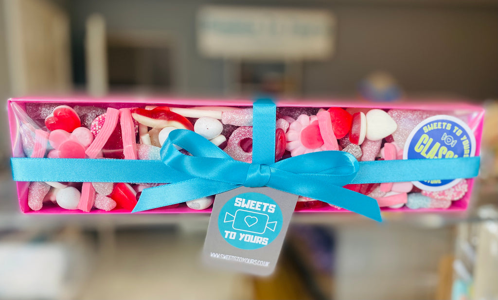 Clear lidded box with pick n mix sweets in and a ribbon bow tie 